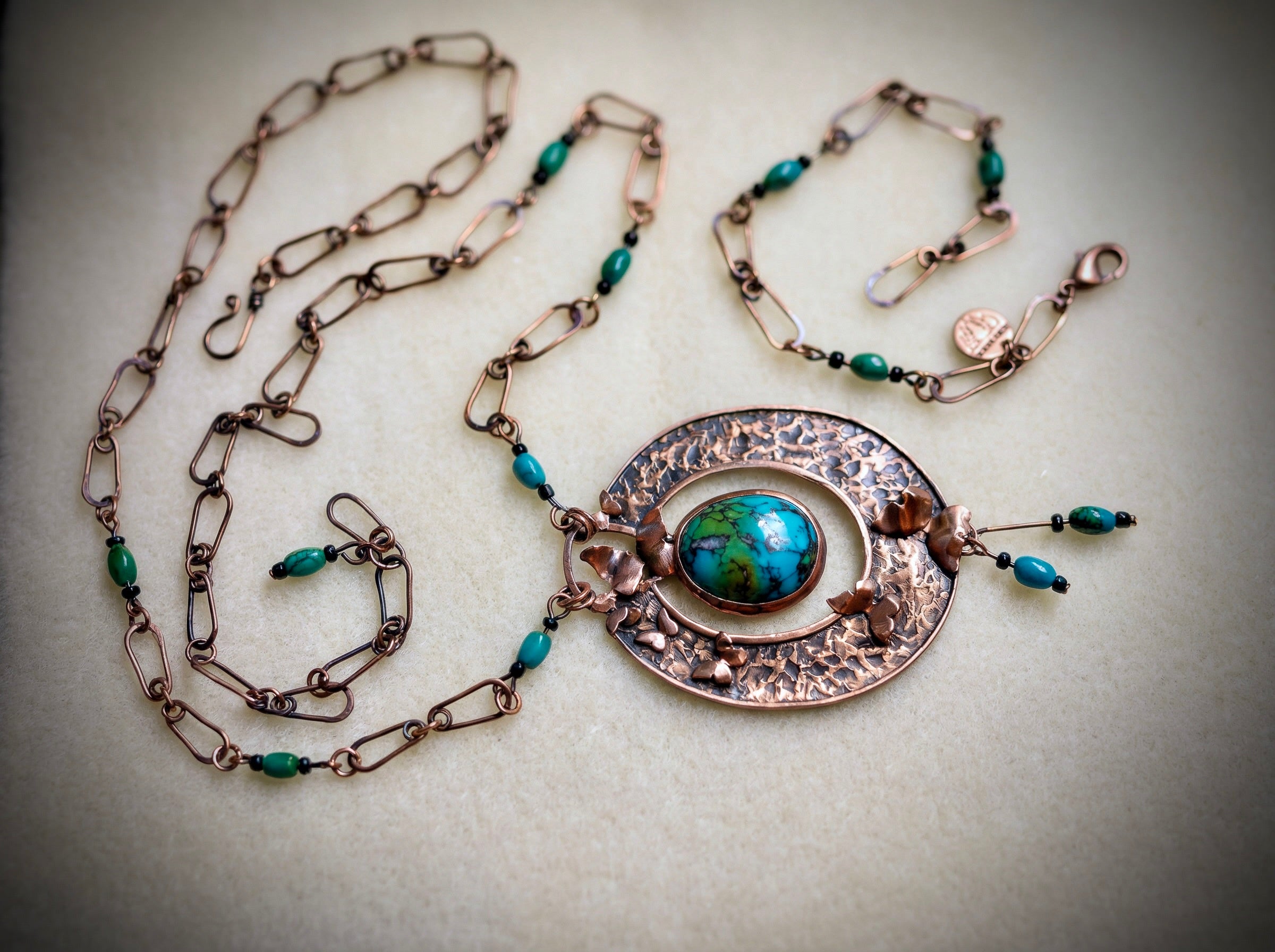 Jewelry set with necklace, bracelet, and earrings on a light background