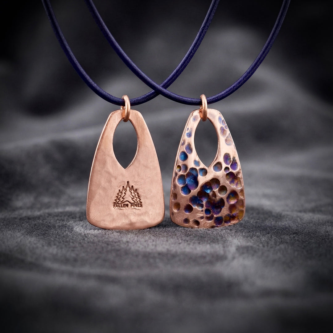 Two unique pendants on a dark fabric background