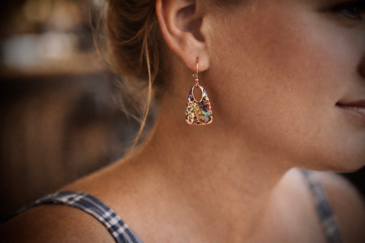 Close-up of a woman wearing a decorative earring with a blurred background