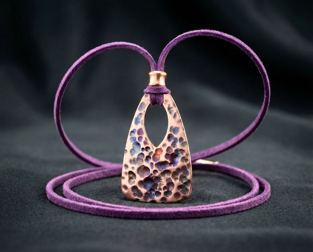 Purple leather necklace with a textured pendant on a dark background