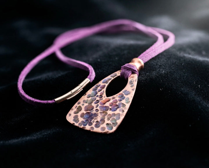 Necklace with a textured pendant on a dark background