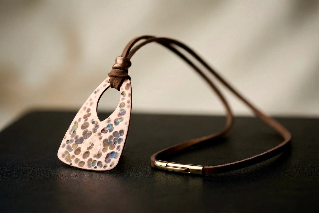 Necklace with a textured pendant on a dark surface