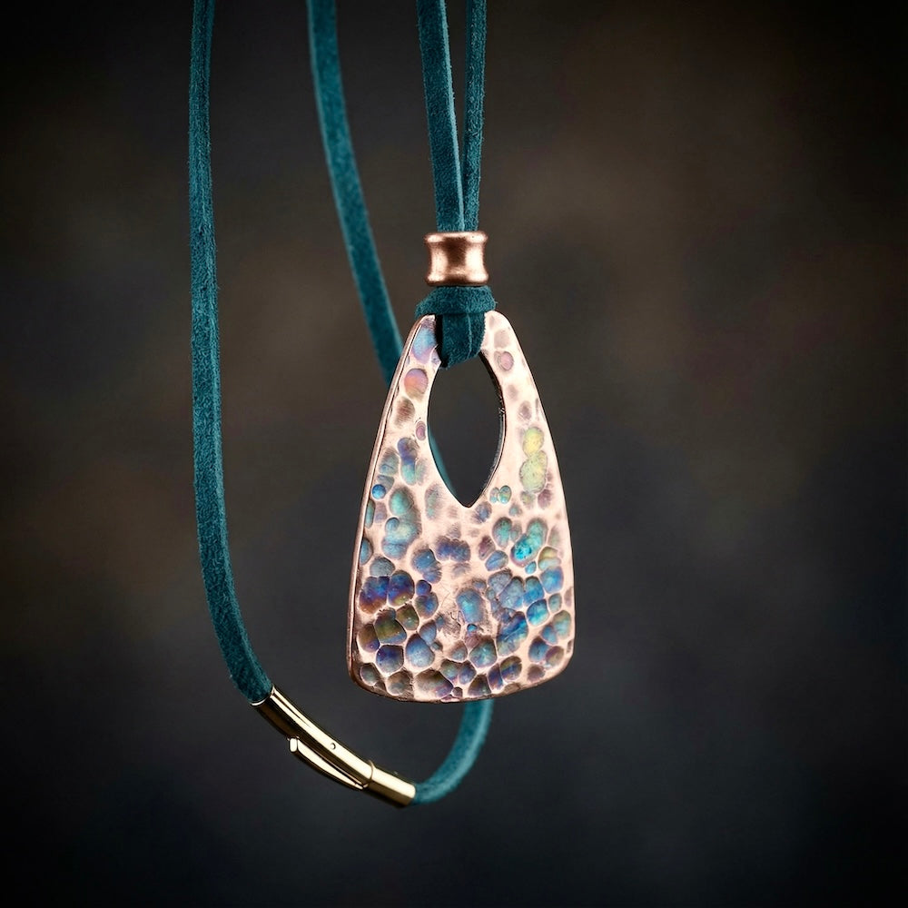 Necklace with a textured pendant on a dark background