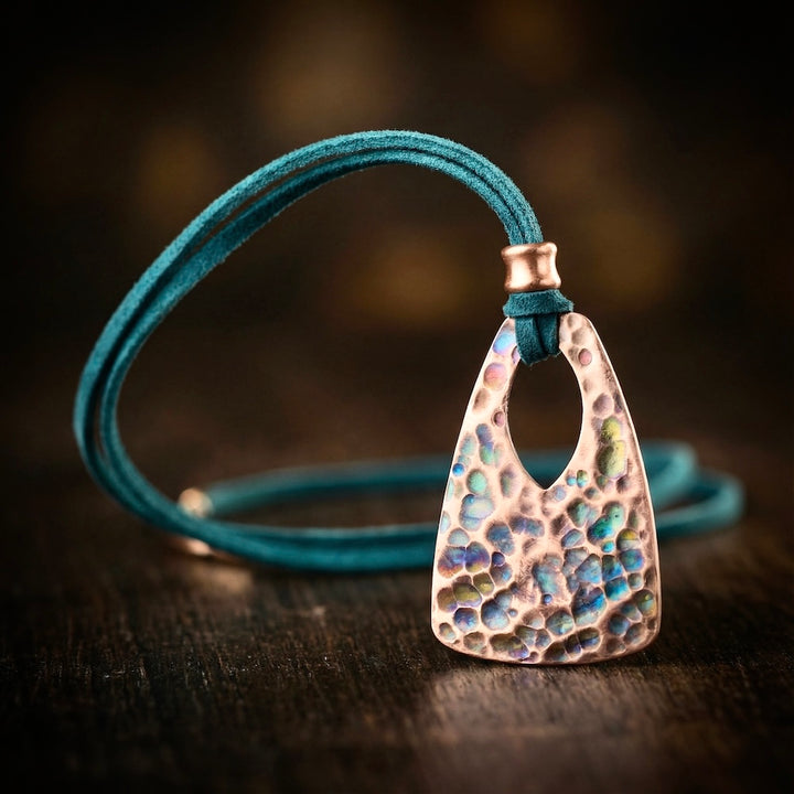 Necklace with a textured pendant on a wooden surface