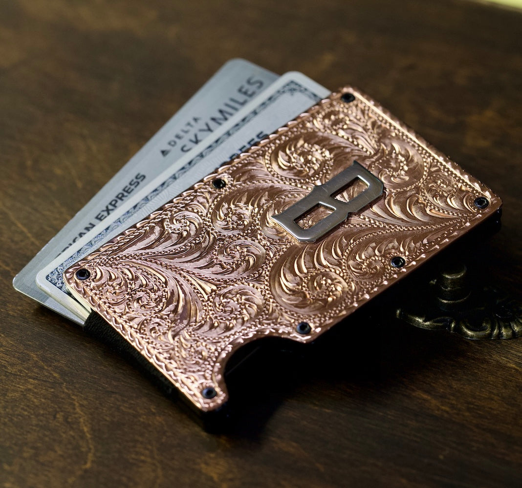 Decorative copper wallet with intricate patterns on a wooden surface