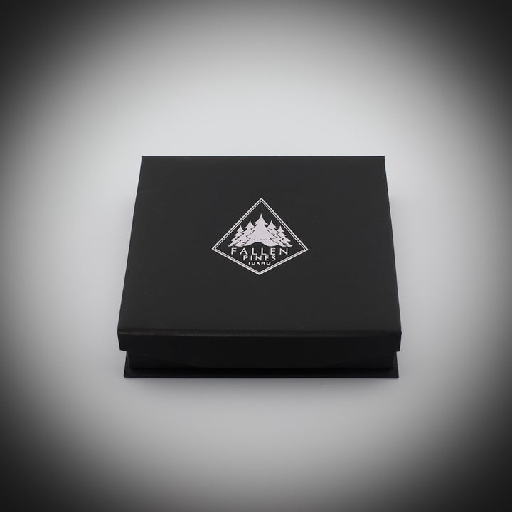 Black box with a Fallen Pines logo on a gray background