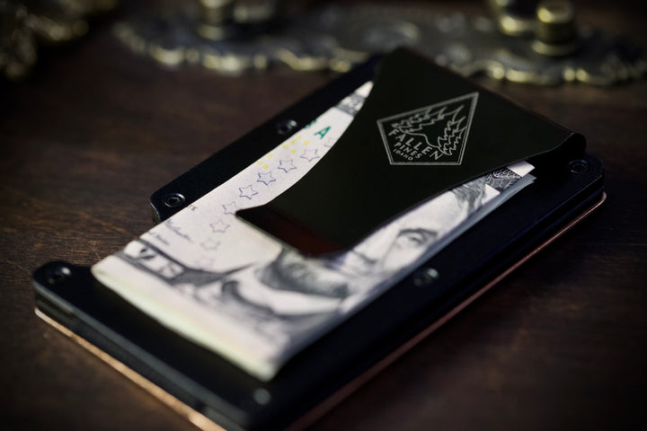 Black wallet with card holder on a wooden surface