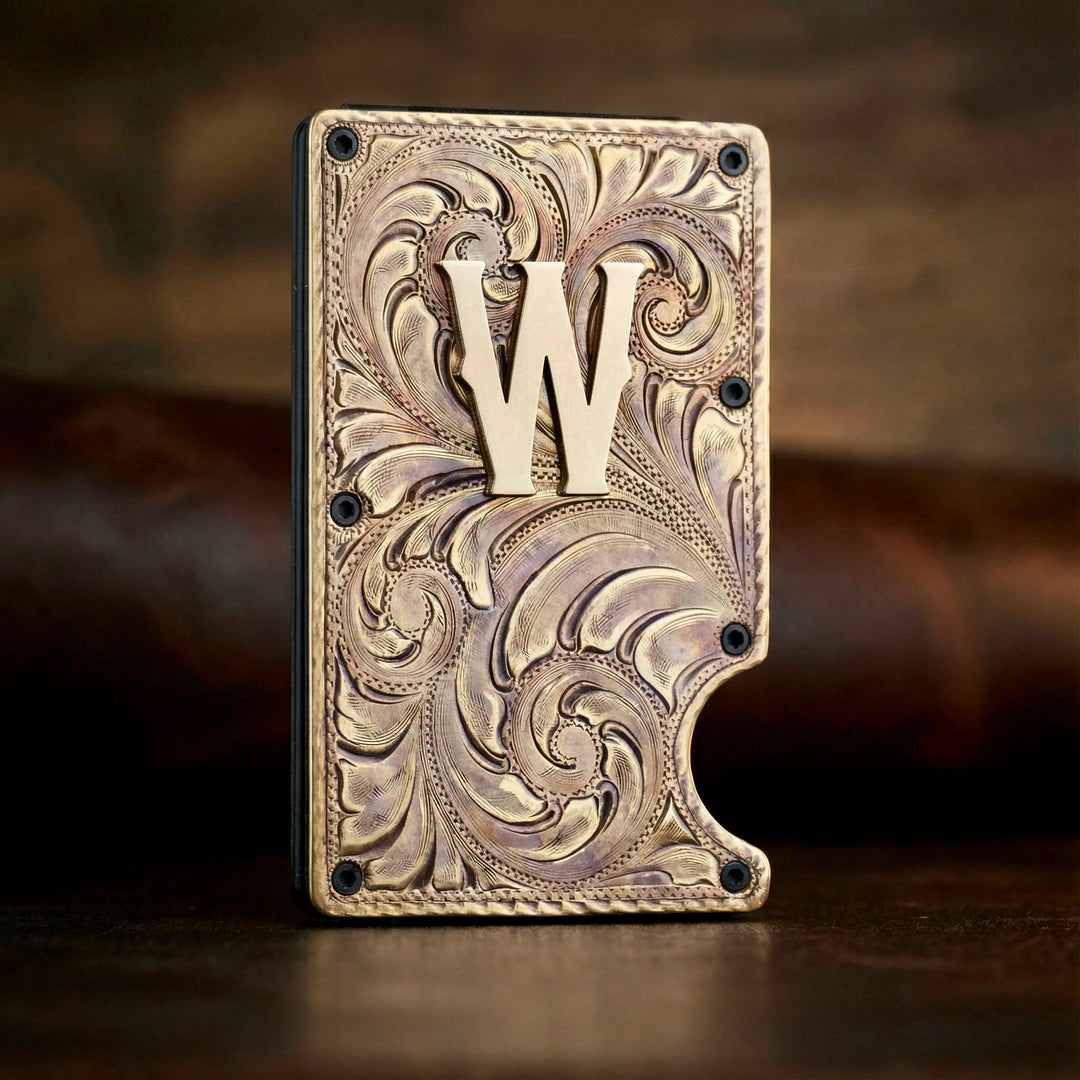 Decorative metal plate with intricate patterns and a prominent 'W' on a dark background