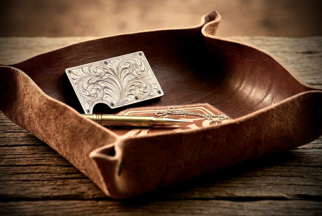 Silver cardholder with decorative design on a wooden tray