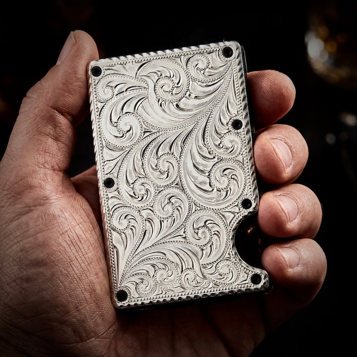 Hand holding a intricately designed metallic object with detailed patterns.