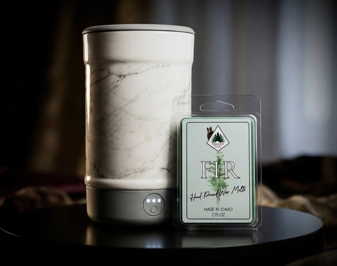 Marble-patterned wax warmer with a 'Fir' wax melt package on a dark surface.